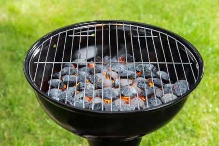 Empty grill with red-hot briquettes.